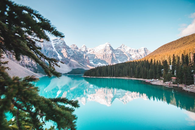Turquoise water of Moraine Lake reflecting snow-capped peaks in Banff, Canada