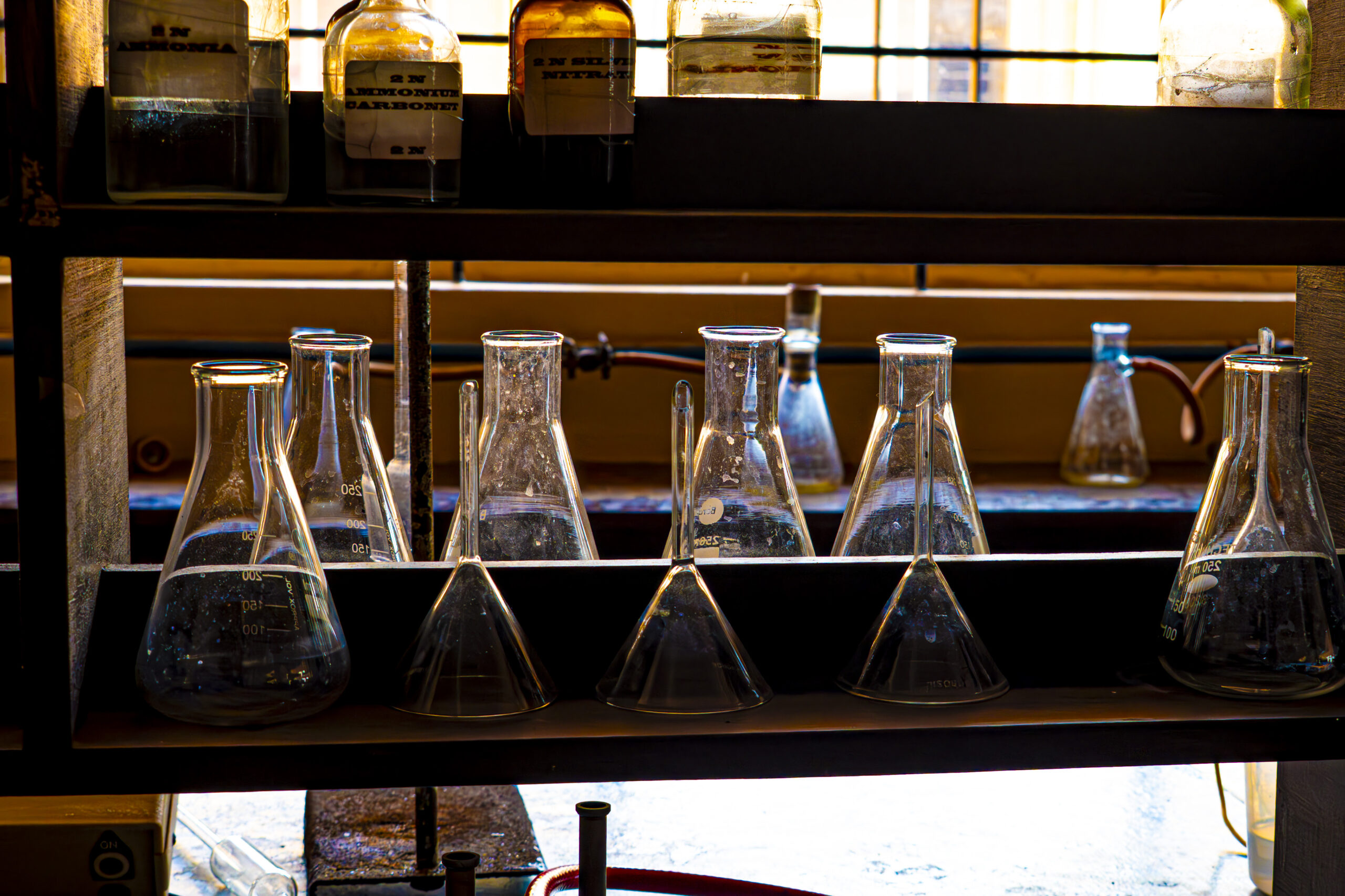 Erlenmeyer flasks on a laboratory shelf